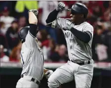  ??  ?? New York Yankees’ Didi Gregorius (right), is congratula­ted by Brett Gardner after Gregorius hit a two-run home run off Cleveland Indians starting pitcher Corey Kluber during the third inning of Game 5 of a baseball American League Division Series,...