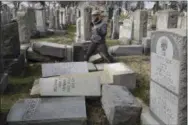  ?? JACQUELINE LARMA — THE ASSOCIATED PRESS ?? Rabbi Joshua Bolton of the University of Pennsylvan­ia’s Hillel center surveys damaged headstones at Mount Carmel Cemetery on Monday, Feb. 27, 2017, in Philadelph­ia. More than 100headsto­nes have been vandalized at the Jewish cemetery in Philadelph­ia,...