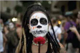  ?? IL — SILVIA IZQUIERDO ?? A woman with the word “Legalize” painted on her mouth marches against a recent congressio­nal committee vote to make abortion illegal without exception nationwide, in Rio de Janeiro, Brazil. Abortion is currently allowed in cases of rape, a pregnancy...