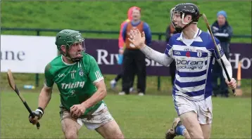  ??  ?? Alan Carton of Cloughbawn on the ball, with Naas defender Rian Boran close at hand.