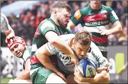  ??  ?? Racing 92’s French centre Olivier Klemenczak (right) runs to score a try against Leicester’s English wing Adam Thompstone during the European Rugby Champions Cup union match between Racing 92 and Leicester Tigers at the Paris La Defense Arena stadium in Nanterre, near Paris on Dec 9. (AFP)