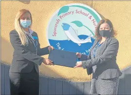  ??  ?? Bluebird Care West Berkshire customer supervisor Emma Holgate presents one of the five laptops to Spurcroft headteache­r Kate Flowerdew