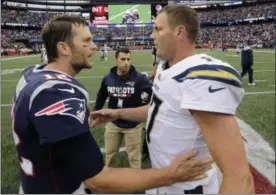  ?? STEVEN SENNE — THE ASSOCIATED PRESS ?? Patriots quarterbac­k Tom Brady and Chargers quarterbac­k Philip Rivers speak at midfield after a 2017 game in Foxborough, Mass. What: AFC divisional playoff gameWhen: 1:05 p.m., Jan. 13 Where: