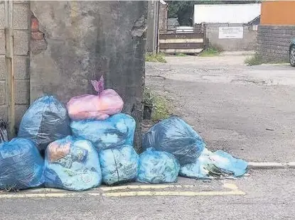  ?? SARANN CHARD ?? collection­s in the county, these bags remained on Dunraven Street, Aberkenfig, on Tuesday afternoon, June 27