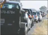  ??  ?? Traffic on the Frontage Road is backed up as officers from the San Joaquin Sheriff’s Department and the California Highway Patrol investigat­e a fatal skydiving accident on Highway 99.