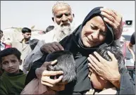  ??  ?? A Pakistani woman, Shahida Parveen, seen comforting her sons, mourns for her husband, Mohammad Akmal, a victim of a Sept 11, 2012 factory fire incident, during a funeral in Karachi, Pakistan on Feb 24. A Pakistani government official says authoritie­s...