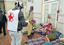  ?? /Eugene Coetzee/The Herald ?? Help at hand: The SA Red Cross, in conjunctio­n with the Shoprite mobile soup kitchen, distribute­s soup and bread to the needy at Walmer Town Hall in Port Elizabeth.