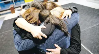  ?? DARREN MAKOWICHUK ?? The five daughters of a sexual-assault victim embrace at the Calgary Courts Centre on Wednesday after Wayne Howard Bernard was found guilty of the March 28, 1995, attack.