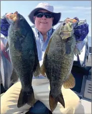  ?? (Photo submitted by Rowe Waelder) ?? Rowe Waelder admires two of the 25 smallmouth bass he caught recently while fishing with Paul Delaney on Lake Michigan.