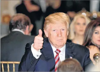  ?? AP PHOTO ?? President Donald Trump gives a thumbs-up as he has Thanksgivi­ng Day dinner at his Mar-a-Lago estate in Palm Beach, Fla., Thursday.