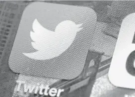  ?? Richard Drew / Associated Press ?? A Twitter app is on an iPhone screen. A change announced Tuesday is another try by the company to make its service easier to use, and to attract new users.