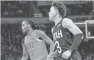  ?? NATHAN J. FISH/THE OKLAHOMAN ?? Oklahoma City guard Cason Wallace (22) and Utah guard Keyonte George (3) run up court in the second quarter Monday night at Paycom Center.