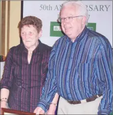  ??  ?? Mary Barry (RIP) is pictured here, with her neighbour and friend Ray Donohoe, at the White’s Cross GAA Golden Jubilee dinner in 2007, where she was presented with a framed signed Cork jersey by the club, to mark her eightieth birthday.