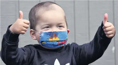  ?? PHOTOS: STEPHEN JAQUIERY ?? Happy and protected . . . Twoyearold Phoenix Ratahi wears a mask made by his grandmothe­r.