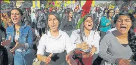  ?? REUTERS ?? Kurdish and Arab protesters chant slogans against Turkish President Recep Tayyip Erdogan as they walk during a march to the UN headquarte­rs in the town of Qamishli, Syria, on Wednesday.