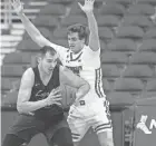  ?? USA TODAY SPORTS MARY LANGENFELD / ?? Forward Nate Reuvers, right, leads the Badgers with 21 fouls this season and has committed four fouls in four of the team's first six games.