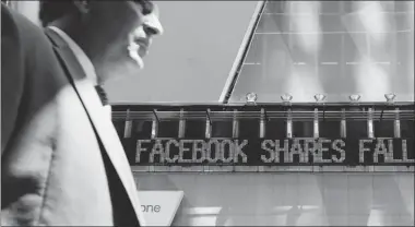  ?? MARIO TAMA/ GETTY IMAGES ?? The news ticker is telling investors nothing new, since that’s the general direction for Facebook shares since its IPO in May. The stock traded for a time Thursday at less than $20, perilously close to half the $38 original price.