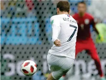  ??  ?? Antoine Griezmann scores his side’s second goal during the quarterfin­al match between Uruguay and France at the 2018 soccer World Cup in the Nizhny Novgorod Stadium, in Nizhny Novgorod, Russia, Friday, July 6, 2018. (AP)