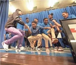 ?? STU BOYD II / THE COMMERCIAL APPEAL ?? NLE Choppa dances with students at Cornerston­e Elementary on Oct. 18 in Memphis.