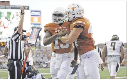  ?? JAY JANNER / AMERICAN-STATESMAN ?? Quarterbac­k Jerrod Heard (left, with tight end Andrew Beck) showed his potential against California as he amassed 527 total yards in his second career start for the Longhorns. But Heard has struggled the past two weeks against Oklahoma State and TCU.