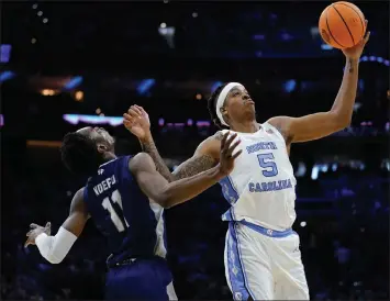  ?? AP ?? North Carolina's Armando Bacot, right, collides with St. Peter's KC Ndefo during the first half of the Tar Heels win in the Elite 8 of the NCAA tournament on Sunday in Philadelph­ia.