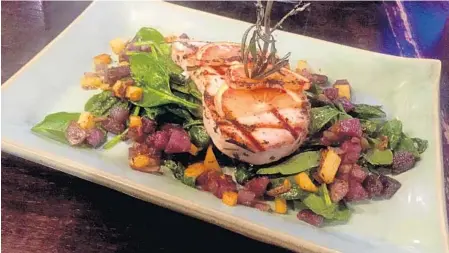  ?? LAUREN DELGADO/STAFF ?? Outpost Neighborho­od Kitchen offers Not Your Typical Tuesday deals that vary each week — recently the restaurant served rosemary grilled swordfish.