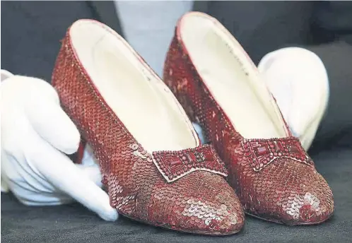  ?? ?? One of the pairs of ruby slippers Judy Garland wore in The Wizard of Oz, below