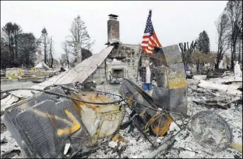  ?? Jeff Chiu The Associated Press ?? Larry Keyser looks around Wednesday as he and volunteers from Samaritan’s Purse disaster relief sift through remains of his family’s home, which was destroyed by fires in the Coffey Park area of Santa Rosa, Calif.