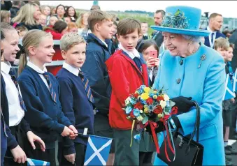  ?? ANDREW MILLIGAN/ AGENCE FRANCE-PRESSE ?? Britain’s Queen Elizabeth formally opens Scotland’s biggest infrastruc­ture project in a generation — the third bridge across the River Forth — on Monday, exactly 53 years after she opened the second. The $1.7 billion Queensferr­y Crossing, the longest...