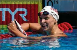  ??  ?? ◄ Katie Ledecky looks at results after the 400-meter freestyle final Saturday. On Sunday, Ledecky dominated the 1,500-meter freestyle with the world’s fastest time this year.