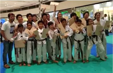  ??  ?? THE BLACK belters of Hanah Taekwondo with Coach Vic Feria (L-R 1st row: Zach Olivo, Auster Jospeh Burata, Hans Samodio, Adrian Galinea, Ethan Chavez, Zane Olivo, Thea Galila; 2nd row: Coach Vic Feria, Eiran Sumaria, Lester Escasinas, Christian Monasque, Davon Pecha, Al Frances Reyes, Mary Angeline Alcantara, Joshua Emmanuel Deita, Ashley Chavez, and Nea Aplasca)