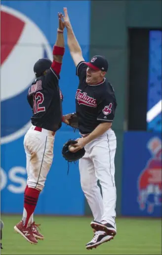  ?? PHIL LONG — THE ASSOCIATED PRESS ?? Jay Bruce, right, celebrates with Francisco Lindor after beating the Royals, 8-4, on Sept. 16 at Progressiv­e Field.