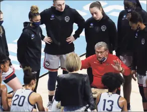  ?? Kin Man Hui / Associated Press ?? University of Connecticu­t head coach Geno Auriemma rallies his team during a timeout in the game against Baylor during their Elite Eight regional championsh­ip game of the 2021 NCAA Women's Basketball tournament in San Antonio on Monday.