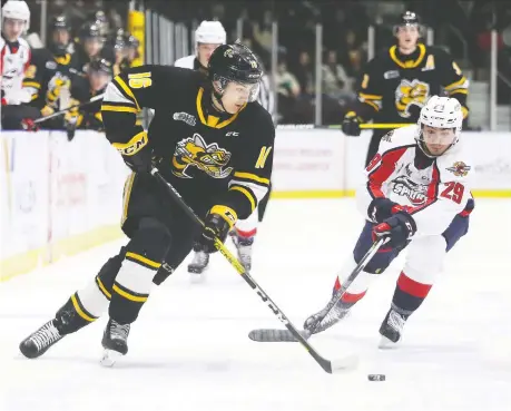  ?? MARK MALONE ?? Sarnia Sting's Theo Hill, left, tries to elude Windsor Spitfires' Daniel D'amico during Tuesday's game at Progressiv­e Auto Sales Arena.