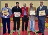  ??  ?? Coach Robert Saulsbury, center, with honorees Reggie Hayes, former head basketball coach at West Haven High; Charlie Bentley, former head basketball coach at Harding High School; Community Service Award recipient Douglas Bethea; and Larry Kelley, head basketball coach at Career High School, at the first Robert H. Saulsbury Basketball Invitation­al at Wilbur Cross High School in 2015.