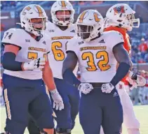  ?? UTC ATHLETICS PHOTO BY LOGAN STAPLETON ?? UTC running back Ailym Ford (32) had a 10-yard touchdown in the first quarter against Mercer for the first points of Saturday’s SoCon showdown in Macon, Ga.