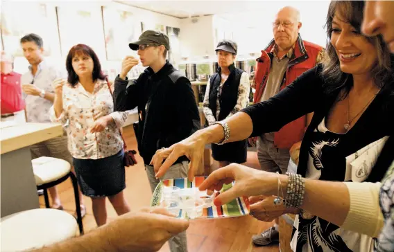  ?? Photos by Sarah Rice / Special to The Chronicle ?? Participan­ts sample the wares at Trio Carmel on Staci Giovino’s three-hour tour strolling from one culinary highlight to the next.