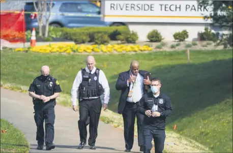  ?? JULIO CORTEZ — THE ASSOCIATED PRESS ?? Police walk near the scene of a shooting at a business park April 6in Frederick, Md.