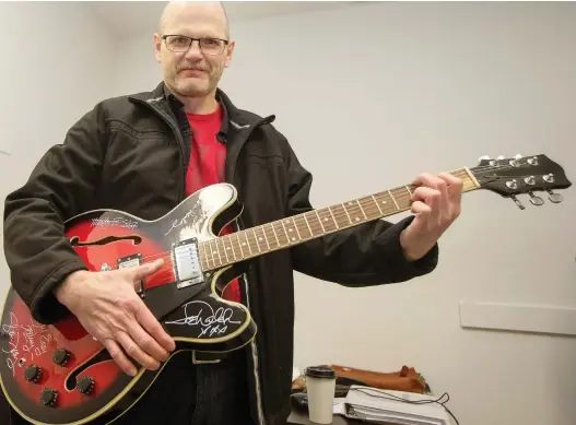  ?? LIAM RICHARDS FILES ?? In this image from 2016, Cam Fuller tests the feel of a guitar autographe­d by the members of the Eagles. The instrument was donated by local businessma­n and guitar collector Lou Paquette to Egadz in support of the organizati­on’s youth employment program.