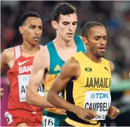 ?? RICARDO MAKYN/MULTI MEDIA PHOTO EDITOR ?? Kemoy Campbell (right) competing in the Men’s 5000m race.