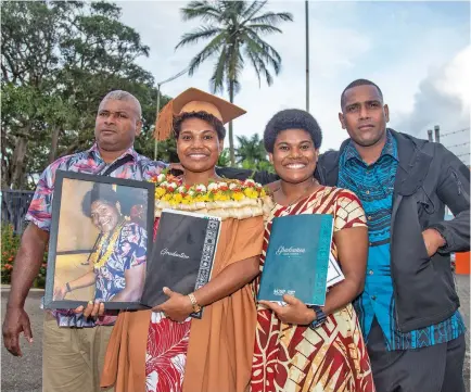  ?? Photo: Leon Lord ?? From left: Father Etuate Bose, Josivini Waiwalu (holding a photoframe of their mother Jowana Nasakure) sister Jokaveti Waiwalu and brother Mosese Waiwalu after the University of the South Pacific graduation event at the FMF Gymnasium, Laucala Bay on May 12, 2022.