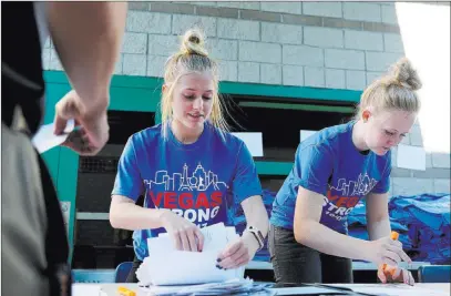  ?? Elizabeth Brumley ?? Las Vegas Review-journal @Elipagepho­to Green Valley High School seniors Cozette Van Wei, left, and Maddie Jensen help the principal of Johnston Middle School pick up an order of Vegas Strong T-shirts on Wednesday. More than 130 schools in the Clark...