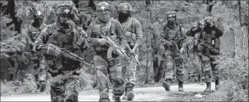  ?? File photo ?? Indian Army jawans patrol a road in Kashmir.