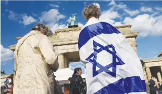  ?? (Christian Mang/Reuters) ?? PRO-ISRAEL SUPPORTERS gather for a rally against antisemiti­sm in front of the Brandenbur­g Gate in Berlin last month.