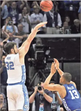  ?? Brandon Dill / The Associated Press ?? North Carolina forward Luke Maye (left) shoots the winning basket as Kentucky guard Isaiah Briscoe (13) defends in the South Regional final game Sunday in the NCAA Tournament.