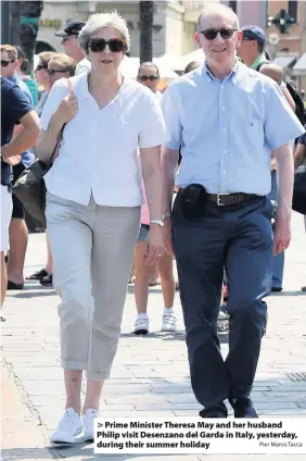  ?? Pier Marco Tacca ?? > Prime Minister Theresa May and her husband Philip visit Desenzano del Garda in Italy, yesterday, during their summer holiday
