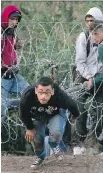  ?? DARKO BANDIC/THE ASSOCIATED PRESS ?? A Syrian refugee runs after entering Hungary from Serbia.