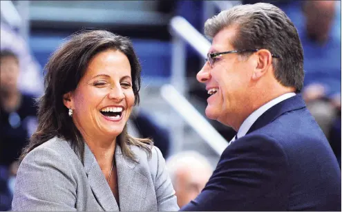  ?? Fred Beckham / AP ?? UConn coach Geno Auriemma speaks with Hartford coach Jennifer Rizzotti before a 2013 game in Hartford.