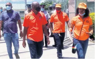  ?? PHOTO BY HOPETON BUCKNOR ?? People’s National Party incumbent (second left) Ian Hayles walking with supporters to the nomination centre in Hanover Western to secure his place on the ballot on August 18.