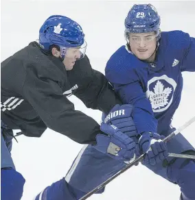  ?? CRAIG ROBERTSON / POSTMEDIA NEWS ?? Defenceman Ron Hainsey, left, battles teammate William Nylander at practice in Toronto on Monday.